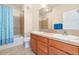 Spacious bathroom with double sinks, tiled countertops, and bathtub shower combo at 4100 Albion St # 307, Denver, CO 80216