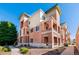 Attractive three-story townhome with brick and stucco exterior, private balconies, and landscaped walkway at 4100 Albion St # 307, Denver, CO 80216