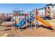 Community playground with colorful slides and climbing structures for outdoor fun at 4100 Albion St # 307, Denver, CO 80216