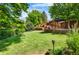 Large backyard features a well-maintained lawn, gazebo, fence, and a landscaped terraced hill at 9916 Spring Hill Ln, Highlands Ranch, CO 80129