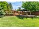 Large backyard with a gazebo, patio, water feature, and mature trees at 9916 Spring Hill Ln, Highlands Ranch, CO 80129