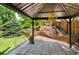 Backyard featuring a patio with metal gazebo and a tiered landscaped area with a small waterfall at 9916 Spring Hill Ln, Highlands Ranch, CO 80129