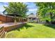 Backyard with a large lawn, gazebo, and landscaped features at 9916 Spring Hill Ln, Highlands Ranch, CO 80129