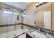 Bathroom featuring updated vanity, granite countertop, and shower over tub at 9916 Spring Hill Ln, Highlands Ranch, CO 80129