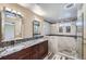 Modern bathroom featuring dual sinks, granite counters, and a glass enclosed shower at 9916 Spring Hill Ln, Highlands Ranch, CO 80129