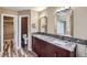 Bathroom with dual vanities, granite countertops, and modern mirrors and fixtures at 9916 Spring Hill Ln, Highlands Ranch, CO 80129