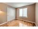 Cozy bedroom with hardwood floors, closet, and natural light from a window at 9916 Spring Hill Ln, Highlands Ranch, CO 80129