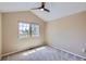 Carpeted bedroom with vaulted ceiling, ceiling fan, single window and outlets on the walls at 9916 Spring Hill Ln, Highlands Ranch, CO 80129