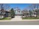 Charming two-story home with a brick facade, well-maintained lawn, and a two-car garage at 9916 Spring Hill Ln, Highlands Ranch, CO 80129