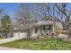 Charming two-story home features a welcoming front porch and beautifully landscaped front yard at 9916 Spring Hill Ln, Highlands Ranch, CO 80129