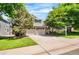 Two-story house featuring brick accents, a two-car garage, and landscaped front yard at 9916 Spring Hill Ln, Highlands Ranch, CO 80129