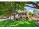 Charming home featuring a well-maintained lawn, mature trees, and a welcoming front porch at 9916 Spring Hill Ln, Highlands Ranch, CO 80129