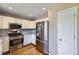 Well-equipped kitchen with stainless steel appliances, white cabinetry, and modern fixtures at 9916 Spring Hill Ln, Highlands Ranch, CO 80129