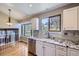 Bright kitchen featuring white cabinets, stainless steel appliances, and granite countertops at 9916 Spring Hill Ln, Highlands Ranch, CO 80129