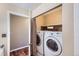 Convenient laundry area with updated washer and dryer, tile floor, and storage at 9916 Spring Hill Ln, Highlands Ranch, CO 80129