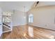 Bright living room with vaulted ceiling, hardwood floors, and staircase with white railings at 9916 Spring Hill Ln, Highlands Ranch, CO 80129