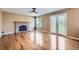 Bright living room features hardwood floors, a brick fireplace, and glass patio doors at 9916 Spring Hill Ln, Highlands Ranch, CO 80129