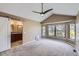 Spacious main bedroom with a vaulted ceiling, ceiling fan, and bathroom at 9916 Spring Hill Ln, Highlands Ranch, CO 80129