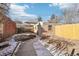 Brick detached garage and fenced backyard with a concrete pathway at 1155 Garfield St, Denver, CO 80206