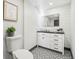 Clean bathroom, featuring a white vanity, geometric floor tile and a walk-in shower at 1155 Garfield St, Denver, CO 80206