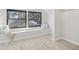 Bright bedroom featuring a built-in window seat and light wood flooring at 1155 Garfield St, Denver, CO 80206