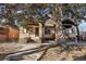 Front view of charming two-story brick home with mature trees at 1155 Garfield St, Denver, CO 80206