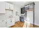 Modern kitchen with white and gray cabinets, quartz countertops, and hardwood floors at 1155 Garfield St, Denver, CO 80206