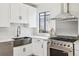 Stylish kitchen featuring stainless steel appliances and a farmhouse sink at 1155 Garfield St, Denver, CO 80206