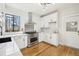 Modern kitchen with white cabinets, stainless steel appliances, and a farmhouse sink at 1155 Garfield St, Denver, CO 80206