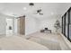 Main bedroom with wood-look floors, a barn door, and large windows at 1155 Garfield St, Denver, CO 80206