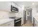 Modern kitchen with stainless steel appliances, white cabinets, and wood-look flooring at 2525 S Dayton Way # 1109, Denver, CO 80231