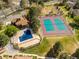 Community aerial view showcases landscaping, tennis courts, and swimming pool at 12406 E Pacific Cir # D, Aurora, CO 80014