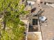 A close aerial view of the townhome's deck area includes a small outdoor seating area, satellite dish and siding detail at 12406 E Pacific Cir # D, Aurora, CO 80014