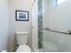 Updated bathroom features a new toilet, shower, and decorative mosaic tile at 12406 E Pacific Cir # D, Aurora, CO 80014