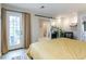 View of a bedroom with access to a patio through french doors and an ensuite bathroom at 12406 E Pacific Cir # D, Aurora, CO 80014