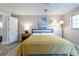 Comfortable bedroom featuring natural light, a bedside table, and a lamp at 12406 E Pacific Cir # D, Aurora, CO 80014