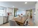 Inviting dining area with wood table, seamlessly connected to a modern kitchen and cozy living space at 12406 E Pacific Cir # D, Aurora, CO 80014