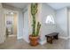 Inviting hallway with a cactus in a clay pot, bench, and stylish decor at 12406 E Pacific Cir # D, Aurora, CO 80014