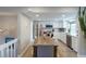Bright kitchen with stainless steel appliances and white cabinets, open to dining area at 12406 E Pacific Cir # D, Aurora, CO 80014