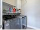 Well-organized laundry room features modern washer and dryer at 12406 E Pacific Cir # D, Aurora, CO 80014