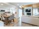 Open concept living space with a modern kitchen, rustic dining area, and cozy living room with a fireplace at 12406 E Pacific Cir # D, Aurora, CO 80014