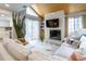 An inviting living room featuring a stone fireplace, wood-paneled ceiling, and sliding glass doors at 12406 E Pacific Cir # D, Aurora, CO 80014