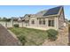 Backyard featuring green grass, gravel, a privacy fence, and a home with solar panels at 4625 Walden Ct, Denver, CO 80249