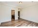 Bedroom boasts an en-suite bathroom, tray ceiling and wood floor at 4625 Walden Ct, Denver, CO 80249