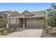 Charming two-story home with stone accents, a well-maintained lawn, and a convenient attached two-car garage at 4625 Walden Ct, Denver, CO 80249