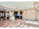 Open-concept kitchen with dark cabinetry, stainless steel appliances, hardwood floors, and a center island at 4625 Walden Ct, Denver, CO 80249