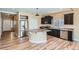 Modern kitchen featuring stainless steel appliances, dark wood cabinets, granite countertops, and a center island at 4625 Walden Ct, Denver, CO 80249