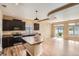 Modern kitchen featuring stainless steel appliances, dark wood cabinets, granite countertops, and a center island at 4625 Walden Ct, Denver, CO 80249