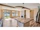 Modern kitchen featuring stainless steel appliances, dark wood cabinets, granite countertops, and a center island at 4625 Walden Ct, Denver, CO 80249