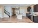 Spacious kitchen featuring stainless steel appliances, dark wood cabinets, granite countertops, and a center island at 4625 Walden Ct, Denver, CO 80249